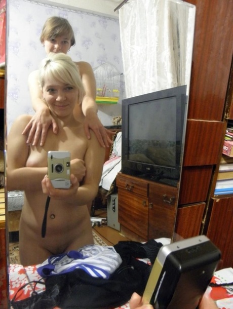 Lesbian babes strip and suck each other's tits while taking selfies