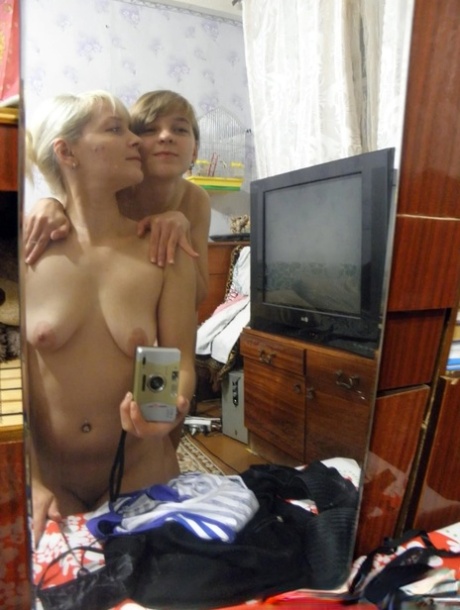 Lesbian babes strip and suck each other's tits while taking selfies