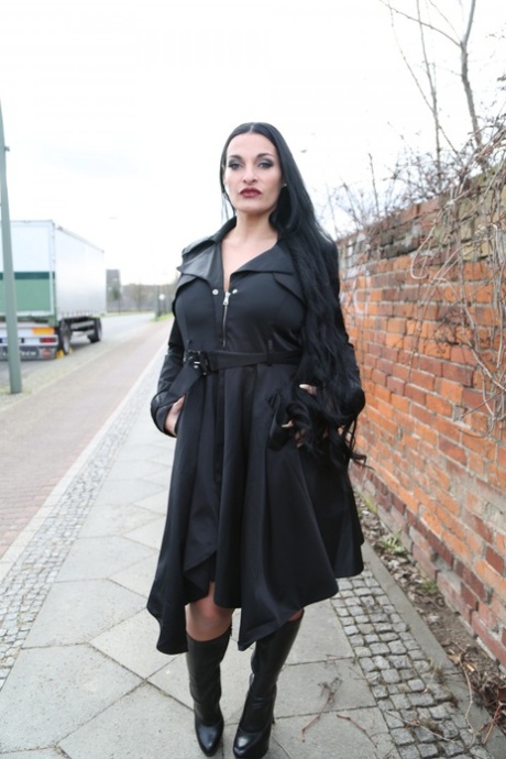 Gorgeous black haired German MILF reveals bulbous & massive big tits outdoors