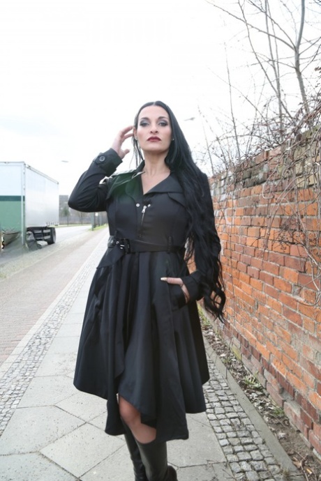 Gorgeous black haired German MILF reveals bulbous & massive big tits outdoors