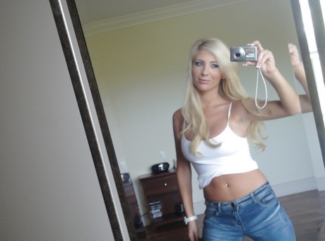 Platinum blonde beauty Tasha Reign taking selfies while getting naked