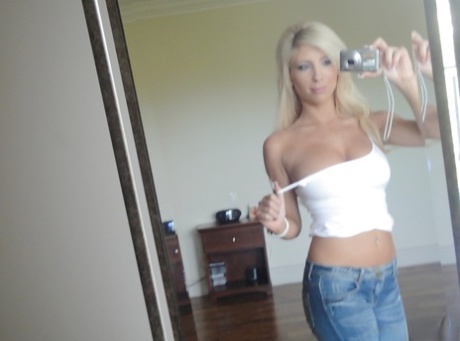 Platinum blonde beauty Tasha Reign taking selfies while getting naked
