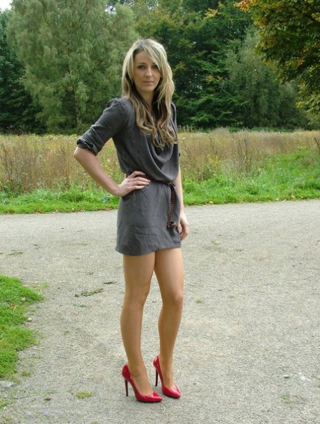 Hot blonde in high heel pumps flaunting her sexy legs and feet outdoors