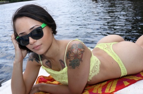 Petite Latina babe Holly Hendrix strips and poses sexily on the boat
