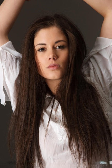 Beautiful teen model Caprice A displaying great legs while stripping naked