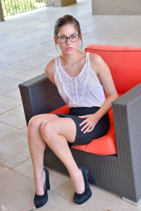 Nerdy teen girl hikes her miniskirt and proceeds to fist her pussy