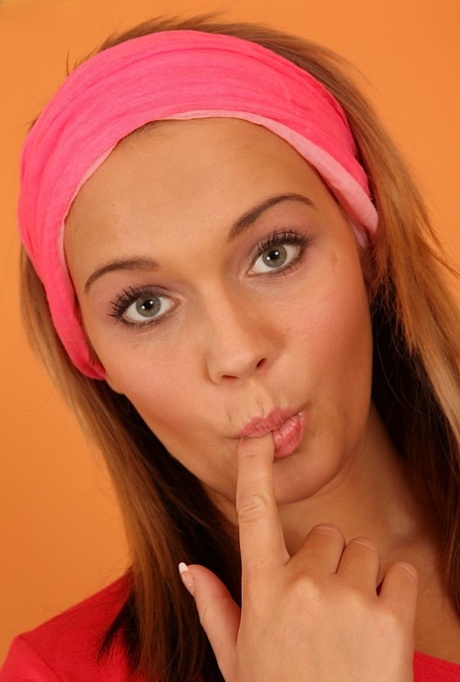 Sweet young girl showcases her hairless pussy after stripping naked