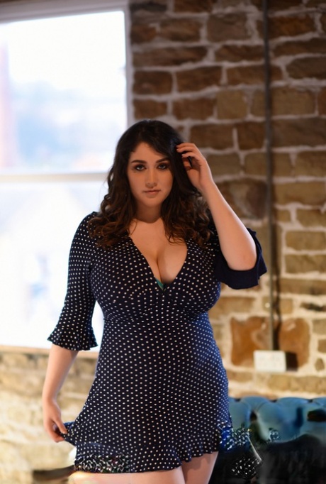 Thick brunette Bella B reveals her large melons and poses topless