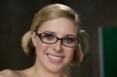 Nerdy pornstar Penny Pax shows her natural tits and poses in sheer pantyhose