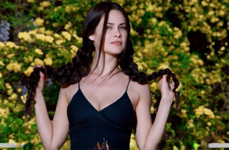Sexy teen Martina Mink gets undressed in braided pigtails by flowering bushes