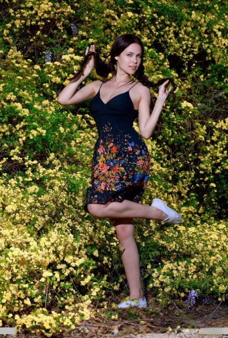 Sexy teen Martina Mink gets undressed in braided pigtails by flowering bushes