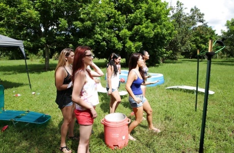 Pretty naked lesbians are standing naked and showing their bodies outdoor