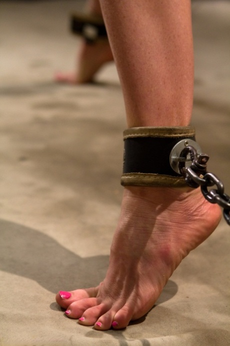 Naked Ariel X endures whipping and a clothespin zipper while in suspension