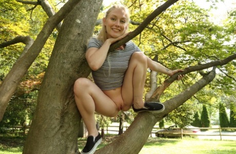 Cute blonde Emma Starletto shows off her flexibility while naked in the yard