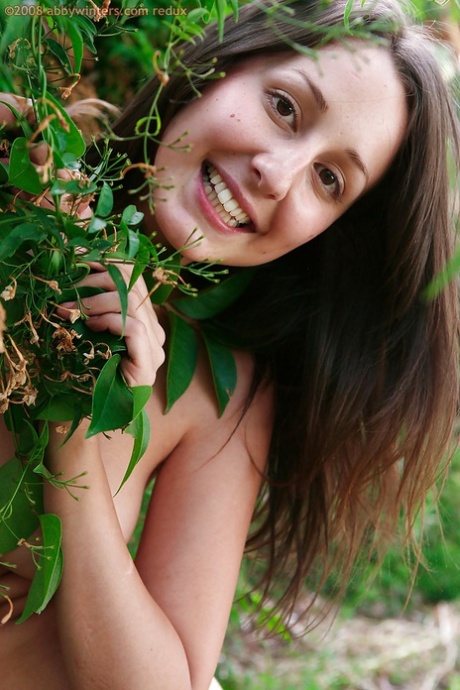 Slender amateur Petria slides jumpsuit down long legs outdoors