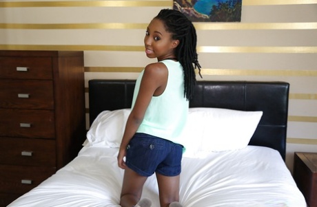 Petite ebony babe Brie Dawn baring tiny teen tits and shaved vagina