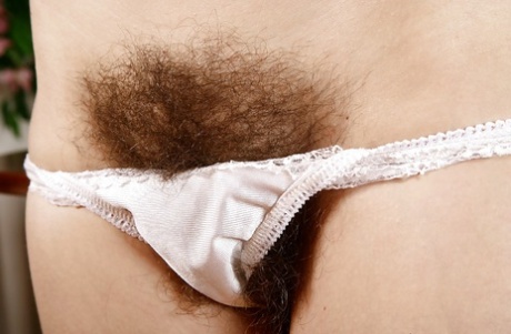Older hirsute woman strips off vintage panties to pet hairy vagina