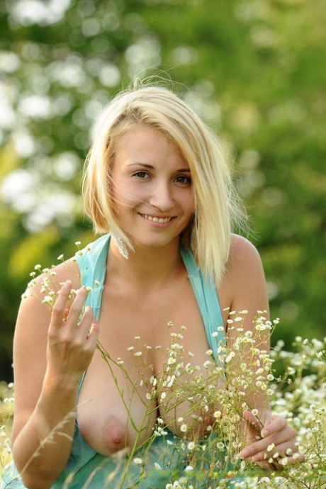 Cute solo girl Isabella D showing off big boobs outdoors in field