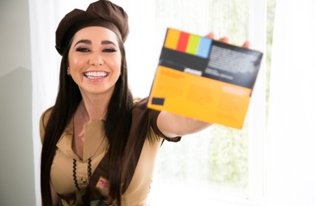 Solo girl hikes up her Brownie's skirt to flash her thong covered butt