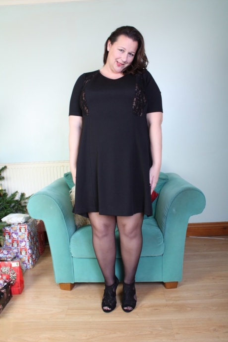 Brunette mom Eva Jayne removes her black dress and flaunts her curves