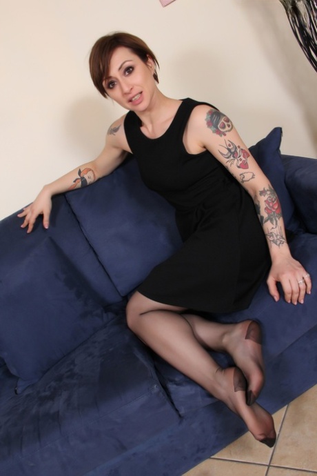 Tattooed female with short hair removes high heels from RHT nylon clad fet