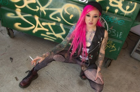 Smoking tattooed Kelsi Lynn in ripped pantyhose flaunting naked ass in alley