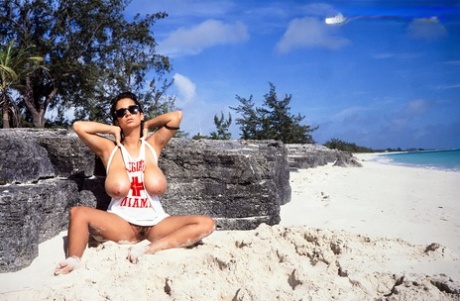 Busty MILF Devon Daniels gets her massive melons covered in sand at the beach