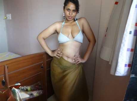 Indian woman lets a boob slip loose from her bra while being a tease