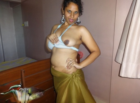 Indian woman lets a boob slip loose from her bra while being a tease