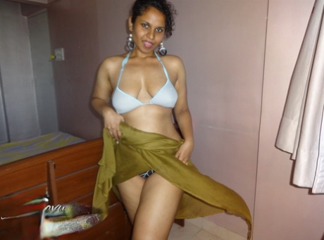 Indian woman lets a boob slip loose from her bra while being a tease