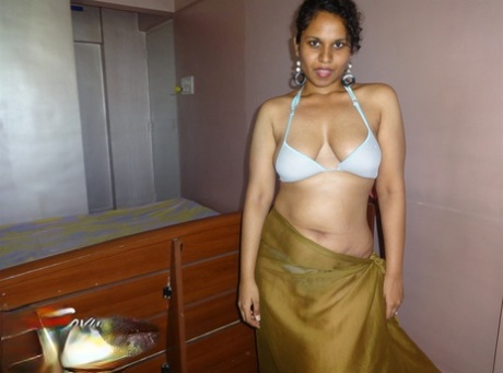 Indian woman lets a boob slip loose from her bra while being a tease