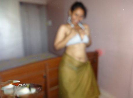 Indian woman lets a boob slip loose from her bra while being a tease