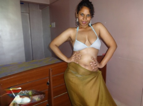 Indian woman lets a boob slip loose from her bra while being a tease