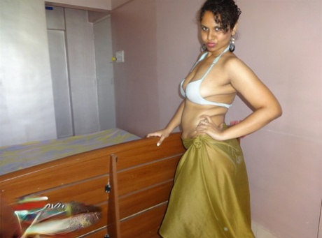 Indian woman lets a boob slip loose from her bra while being a tease