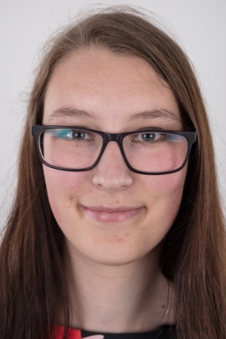 Nerdy teen Katerina stands naked as can be other than her glasses in the nude