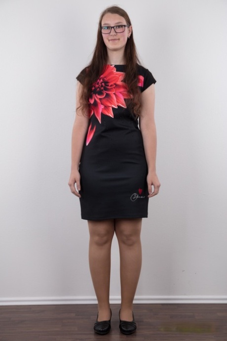 Nerdy teen Katerina stands naked as can be other than her glasses in the nude