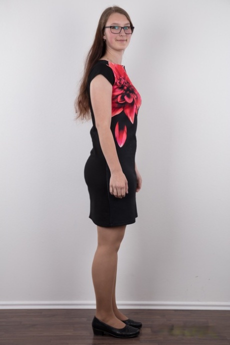 Nerdy teen Katerina stands naked as can be other than her glasses in the nude