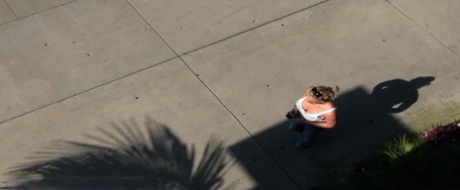 Oblivious busty Karmen Jay's big tits captured in downblouse voyeur photos