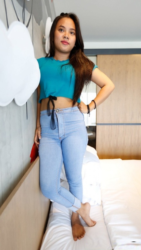 Beautiful Asian teen Nini undresses & shows her big tits before a POV fuck