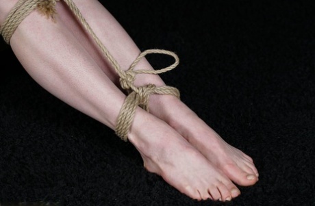 Naked blonde finds her nipples sticking out as she struggles against rope ties