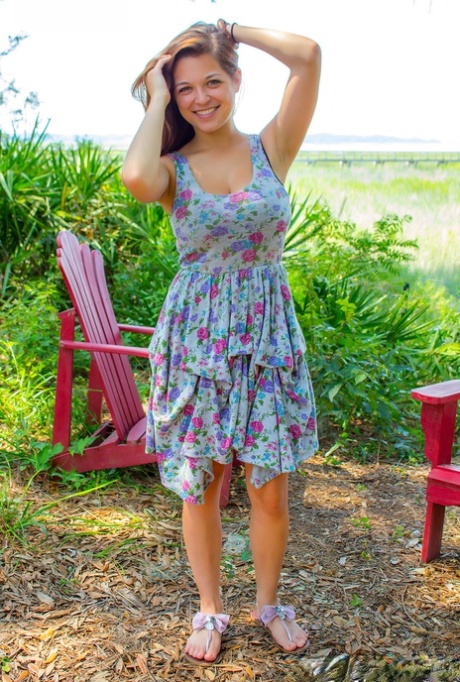 Hot amateur Tessa Fowler disrobing outdoors to tan her big tits in the yard