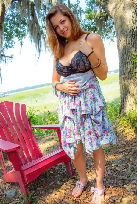 Hot amateur Tessa Fowler disrobing outdoors to tan her big tits in the yard