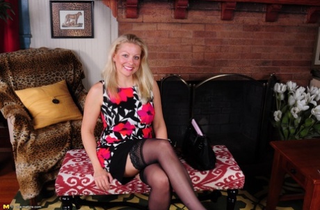 Blonde American housewife strips to black lingerie and stockings
