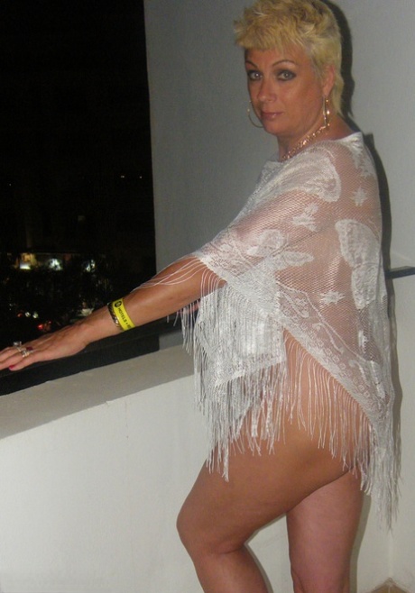 Sexy mature woman Dimonty gets naked after smoking a cigarette on balcony