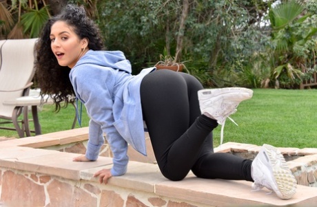 Curly haired amateur slides her thong aside after stripping in the back yard