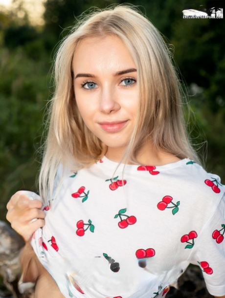 Teen first timer Maya finger spreads her pink twat on a felled tree in a field