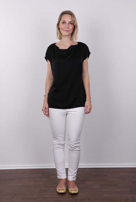 European female Tereza wears no expression while undressing for rent money