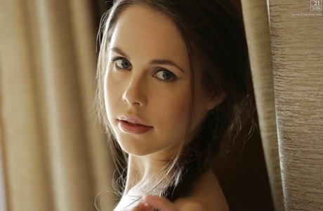 Beautiful solo babe Abril showing off her great legs in underthings