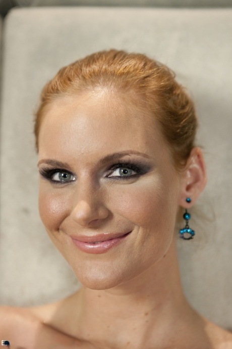 Brazen slut Phoenix Marie happily strips off to spread her big ass cheeks