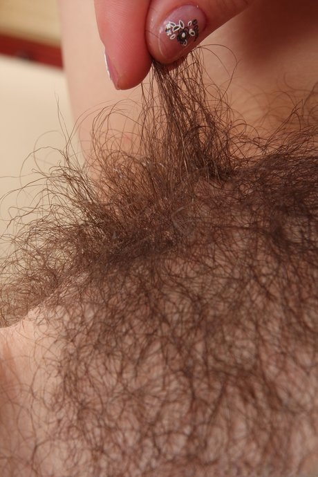 Cute amateur Nessy reveals her hairy pussy and rubs it up close